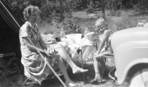 Mor och son vid picknickbordet under en campingtur